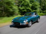 a green car that is driving down the road