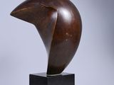 an image of a wooden sculpture of a bird ' s head on a black base
