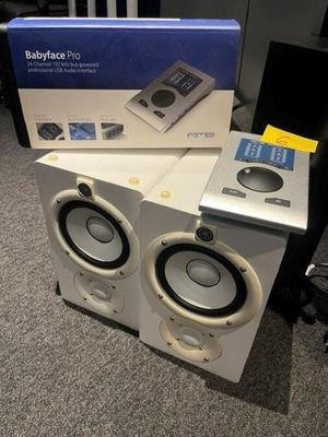 two speakers sitting on top of each other on the floor