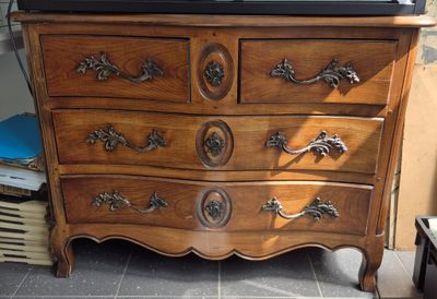 a dresser that has a television on top of it