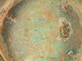 a close up of a metal bowl with rust on it