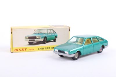 toy car in front of boxed box on white surface
