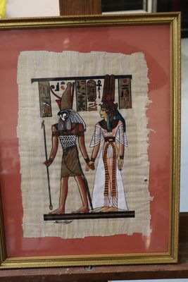 painting of a couple holding hands in front of a picture of an egyptian man and woman