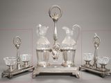 quatre objets en argent et en verre posés sur une table