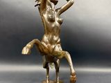bronze statue of a woman on a horse holding a sword
