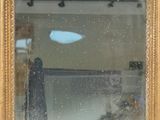 a reflection of a person in a mirror on the wall