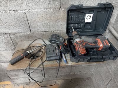 a tool box with a hammer, drill and other tools on a table