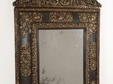 an old mirror hanging on a wall in a white room