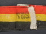 a close up of a piece of cloth with a red, yellow, and black stripe