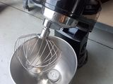a mixer that is sitting on the floor next to a mixer