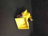 a yellow piece of construction equipment on a black surface