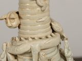 a white vase that has a dragon on top of it