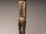 a wooden statue of a man with a hat on his head