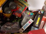 a pile of assorted toys in a bin on the floor