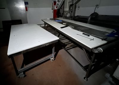 a long table with tools on it in a room