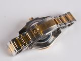 a close up of a watch on a white surface