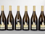 six bottles of wine are lined up in a row