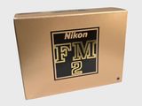 the box is gold and black with a logo on it
