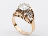 a close up of a gold ring with a diamond on it