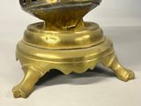 a gold plate with a bird on top of it