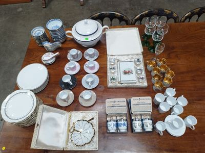 a table that has a lot of dishes and cups on it