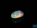 an image of a white fire opal in the dark