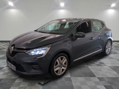the grey car is parked on a checkered floor in a garage