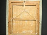 an old wooden picture frame with a rope hanging from it ' s side