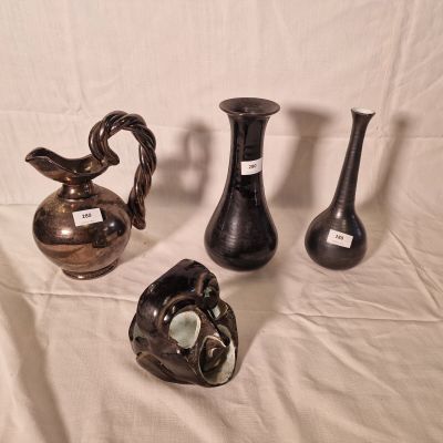 three vases sitting on a table with a white background