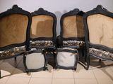four chairs are lined up in a row on a tiled floor