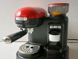 a red coffee maker sitting on top of a white counter