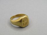 a close up of a gold signet ring with a lion on it