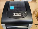 a black printer sitting on top of a cardboard box