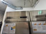 two stainless steel refrigerators that are stacked on top of each other