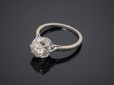 a close up of a diamond ring on a black surface