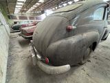 many old cars that are parked in a garage