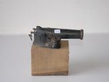 a small toy gun sitting on top of a cardboard box
