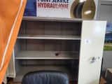 a chair that is sitting in front of a book shelf