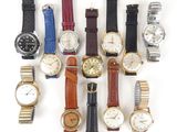 several different types of watches are arranged in a row on a white surface