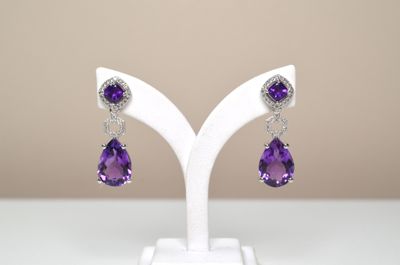 amethorate and diamond earrings on a white stand
