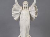 statue of a woman holding a bird in her right hand