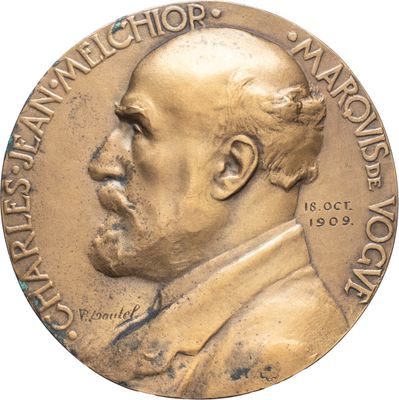 l'image d'une médaille de bronze sur laquelle figure le visage d'un homme