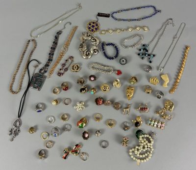 many different types of necklaces and bracelets on the table