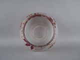 a glass cup with a red design on it