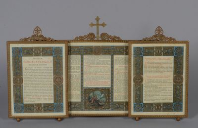an open book with a cross on top of it sitting on top of a table