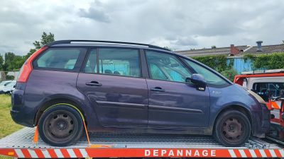 a purple car on the back of a flatbed tow truck