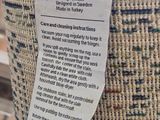 a close up of a woven basket with a tag on it