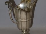 a silver cup that is sitting on a table