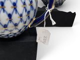 pair of blue and white porcelain teapots on a black box
