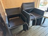 two chairs and a table on the porch